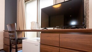 A hotel room with a wooden desk, a television, a chair, and a small white appliance. - SlowTime Hotel Kyoto (Kyoto)
