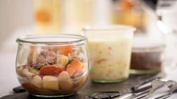 Three glass jars containing different food items on a dark slate surface.