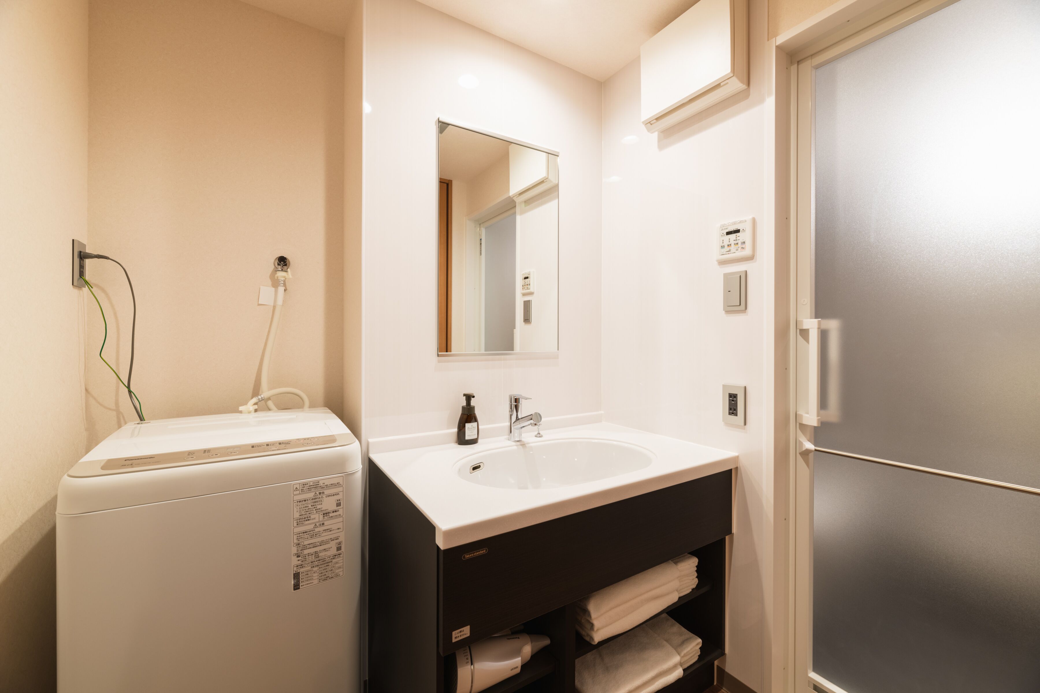Separate tub and shower, hair dryer, slippers, electronic bidet