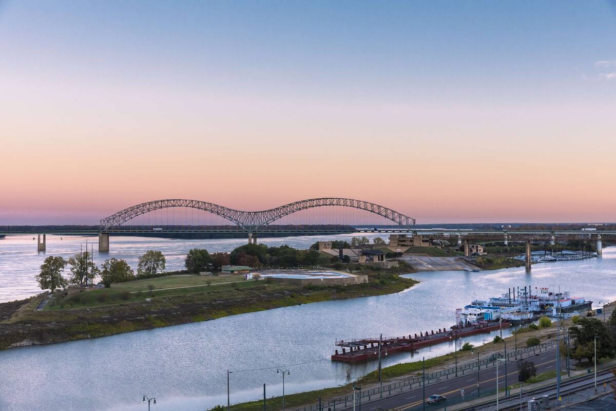A river with a bridge and a boat dock.