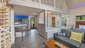 A spacious cabin with a loft bedroom, a kitchen, and a bathroom. - Top of the Line Treehouse Cabin (Cleveland)