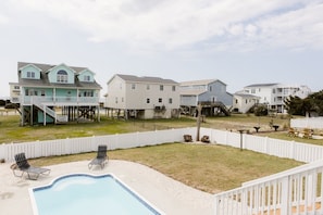 A residential area with houses, a swimming pool, and a white picket fence. - Holden Pattern 4 Bedroom Home by RedAwning (Supply)