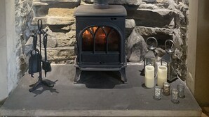 A stone wall with a fireplace and a metal stove. - Teesdale holiday cottage, sleeps 4 + dog at Bank Top, Mickleton, Barnard Castle (Mickleton)