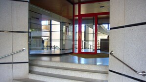 A staircase with metal handrails, leading to an interior space with glass doors and a view of a staircase. - SANTA MARGARITA (ESTUDIO) (Benidorm)
