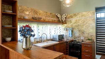 Family Suite, 2 Bedrooms | Private kitchen | Coffee/tea maker, electric kettle, dining tables
