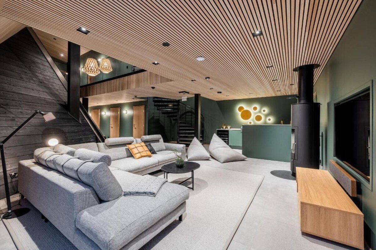 A modern living room with a sectional sofa, a coffee table, and a TV.