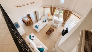 A spacious living area with a high ceiling, a dining table, sofas, and a large window with curtains. - Stunning Villa Sana Perfect Condition, Private 100 m³ Pool & 1000m2 Garden WIFI (Muğla)
