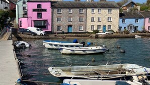 A waterfront scene with a pink building labeled "FERRY BOAT INN" and several boats docked at the pier. - Spacious,  Well Equipped Cottage Near South  Devon coast - Sleeps 10 (plus2) (Slapton, Near Kingsbridge)