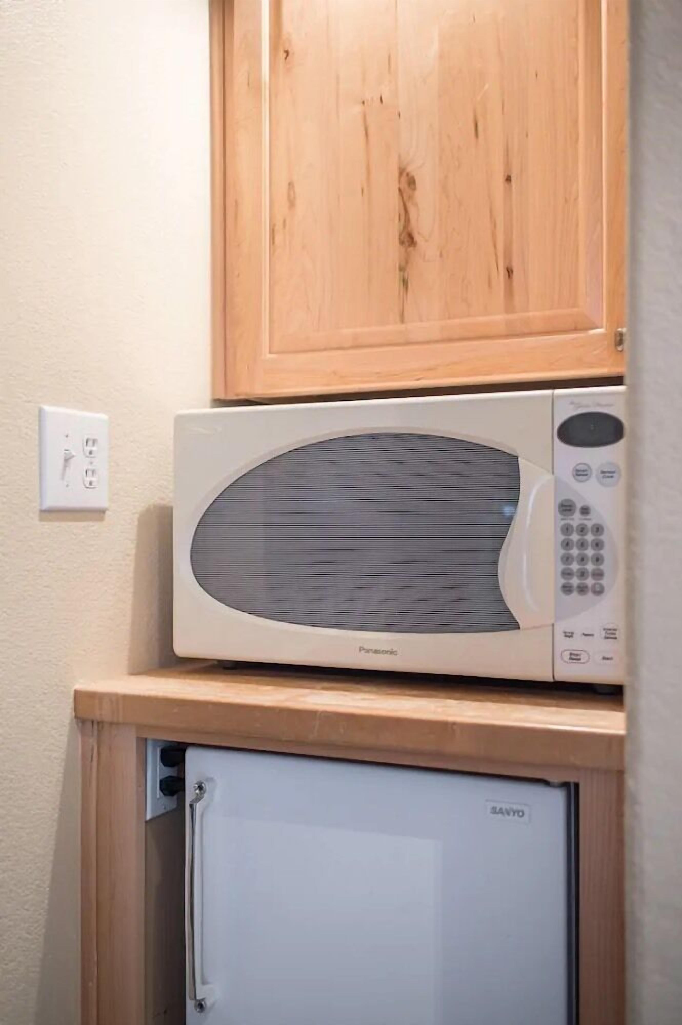 A compact kitchen with a microwave and a mini-fridge.