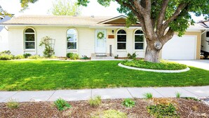 A single-story house with a front yard, a driveway, and a garage.