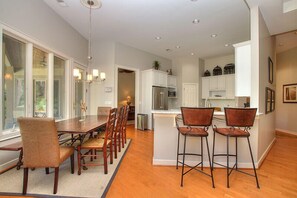 Enjoy meals in the open-plan kitchen and dining area, featuring a central island with sink and microwave.