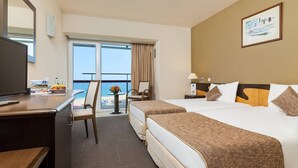 A hotel room with a bed, a desk, a chair, a TV, and a view of the ocean. - Ana Hotels Europa Eforie Nord (Eforie)