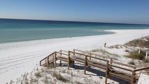 A sandy beach with a wooden walkway leading to the water. - 1 bedroom, 2 Full bath condo in Sandestin  (Miramar Beach)
