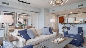 A modern living room with a sofa, armchairs, a coffee table, and a chandelier. - 1 bedroom, 2 Full bath condo in Sandestin  (Miramar Beach)
