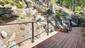 A wooden deck with chairs, surrounded by a metal fence, overlooking a rocky terrain with trees. - 1 Mi to Heavenly Resort: Cozy Home w/ Deck! (Stateline)