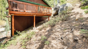 A wooden cabin with a balcony, surrounded by trees and a rocky hillside. - 1 Mi to Heavenly Resort: Cozy Home w/ Deck! (Stateline)