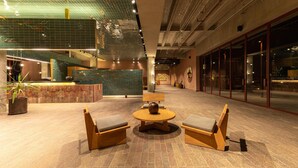 A spacious lobby with a reception desk, seating area, and a large window. - Albor San Miguel de Allende, Tapestry Collection by Hilton (San Miguel de Allende)