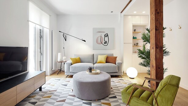 A modern living room with a grey sofa, a round ottoman, and a green armchair. - Salamanka by FeelFree Rentals (Donostia)