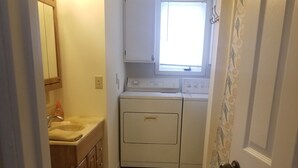 A compact laundry room with a washing machine, dryer, and a small sink. - Quite and cozy / Boat ramp nearby.  (Minster)