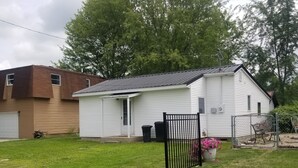 A single-story house with a white exterior and a dark roof. - Quite and cozy / Boat ramp nearby.  (Minster)