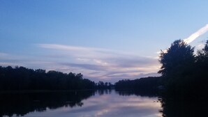 A calm river with trees on both sides and a clear sky. - Quite and cozy / Boat ramp nearby.  (Minster)