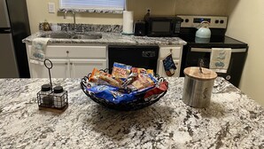 A kitchen with a granite countertop, a microwave, a stove, and a sink. - 🌹Southern’s Beauty 1🌹 (Kenner)