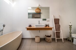 A modern bathroom with a freestanding bathtub, a wooden vanity with a mirror, and a towel rack. - Splendid Private Villa, 2 BR, Canggu With Staff (Canggu)