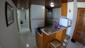 A compact kitchen with a wooden countertop, a sink, a refrigerator, and a microwave. - SEA VIEW APARTMENT CLOSE TO THE BEACH (San Andrés y Providencia)
