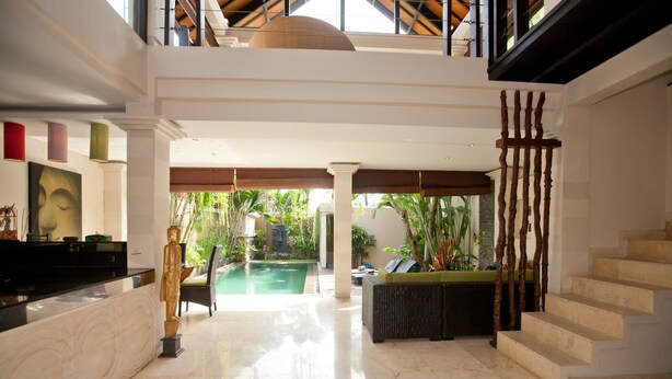 A spacious lobby with a pool, a staircase, and a reception area. - Harmony Villa Dua (Kerobokan)