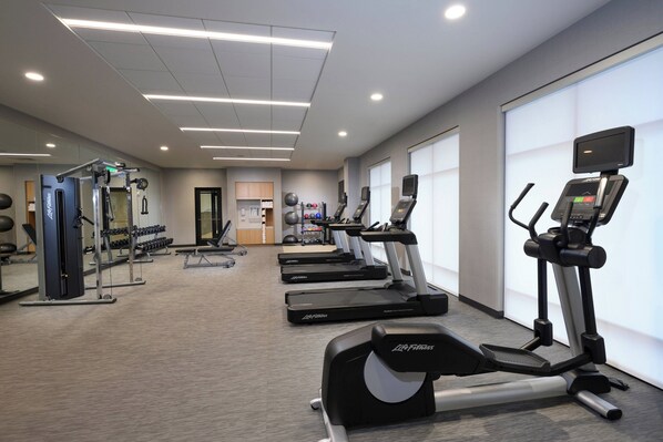 A gym with treadmills, weight machines, and exercise balls. - Courtyard by Marriott Charlotte Waverly (Charlotte)
