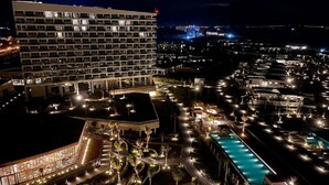 A large hotel with multiple floors, a swimming pool, and well-lit outdoor areas. - This is an apartment of 5* Alma resort at Bai Dai beach in Khanh Hoa (Nha Trang) (Cam Lam)