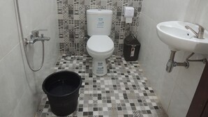 A bathroom with a toilet, sink, and shower. - Srikayah by Ndalem Beong (Borobudur)