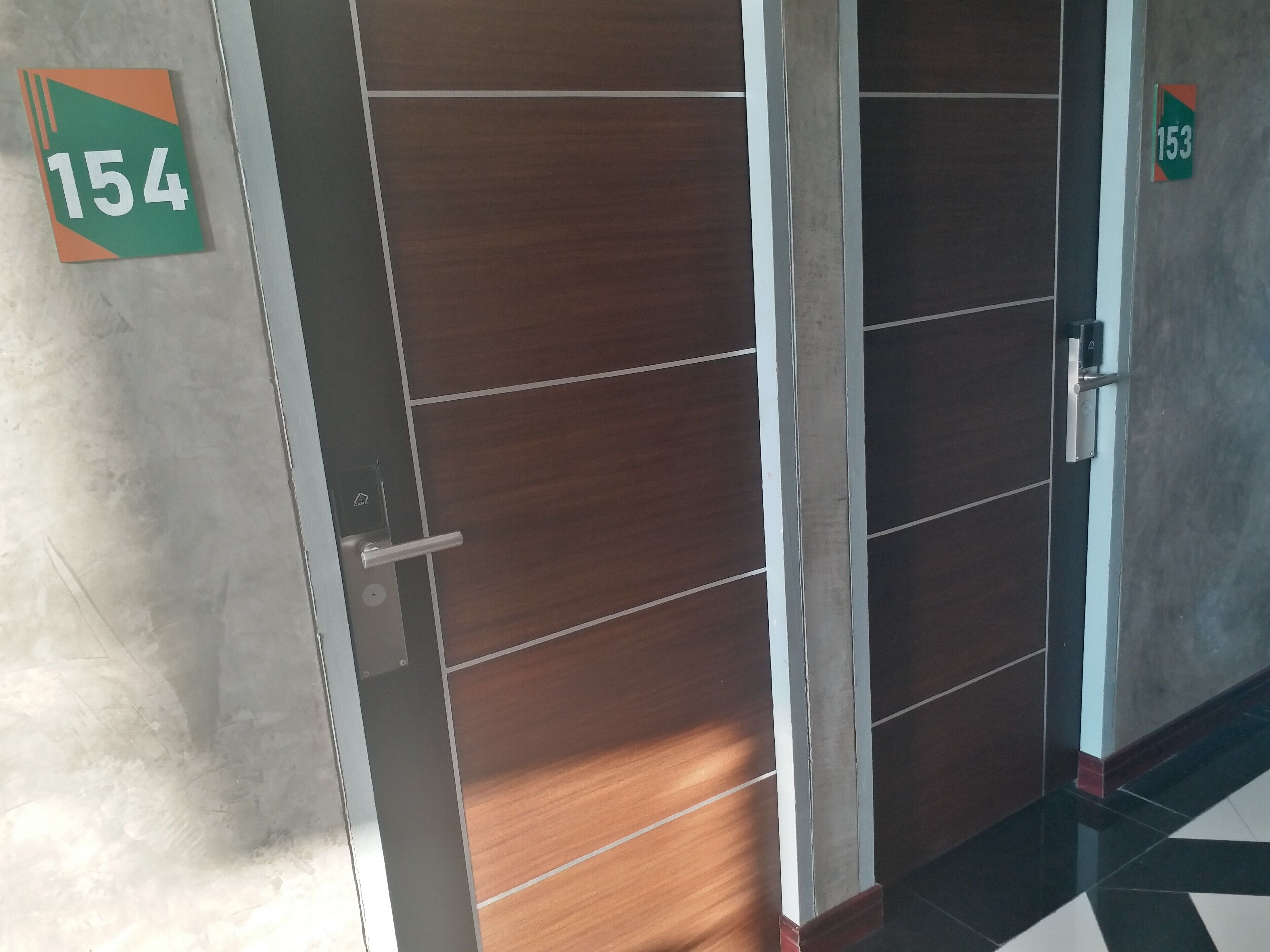 Puerta de una habitación de hotel con una placa que indica el número 154.