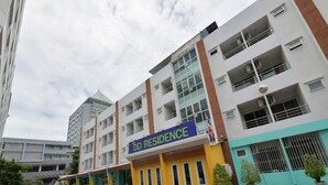A multi-story residential building with a sign reading "DD RESIDENCE".
