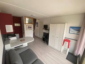 A compact living space with a kitchenette, a sofa, a wardrobe, and a television. - Studio for 4/5 people with balcony, ski-in/ski-out, ski locker, parking, elevator (Arette)