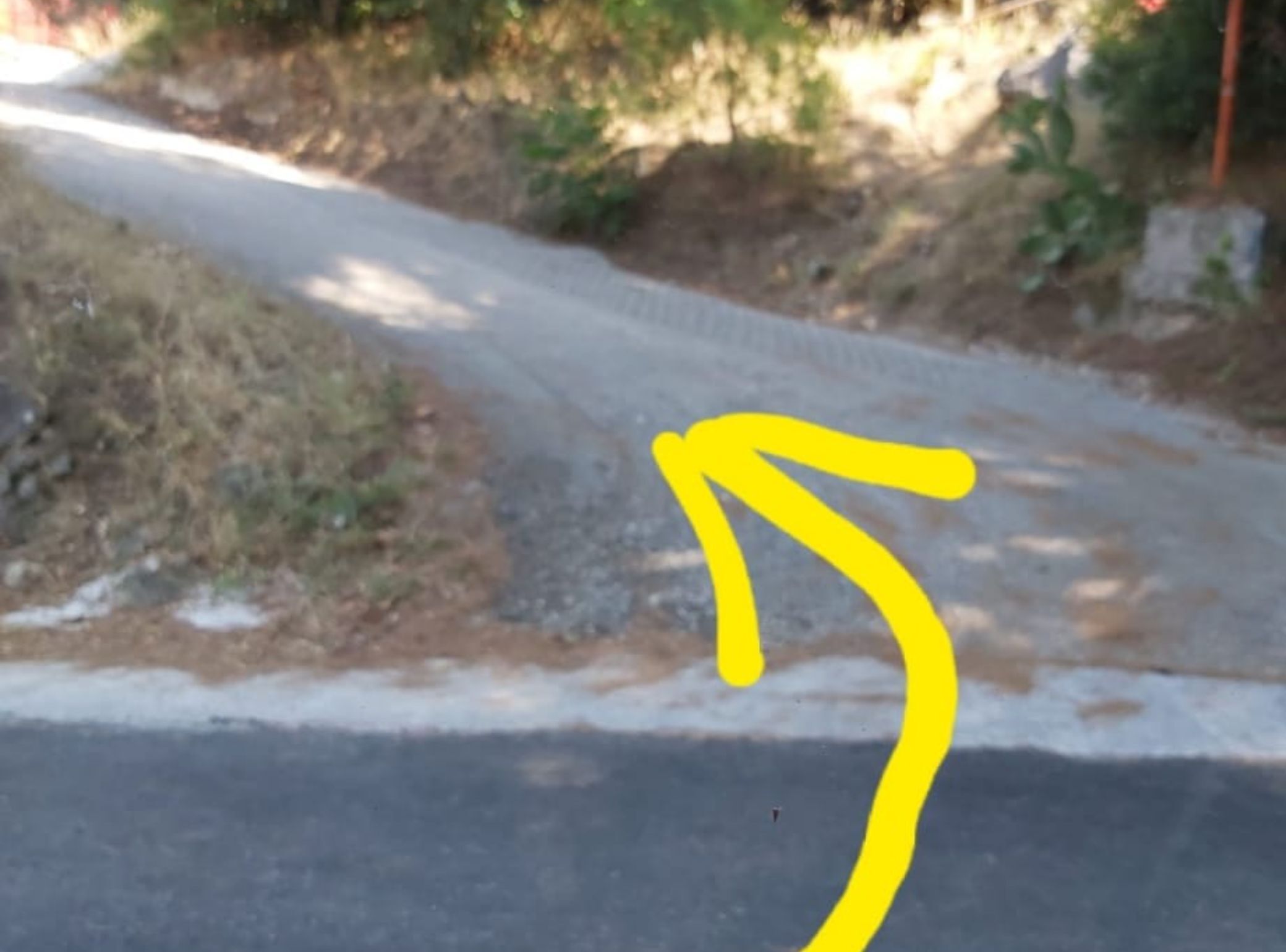 A road with a yellow arrow pointing to the right.