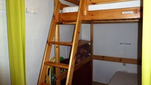 A bunk bed with a wooden ladder, a white mattress, and a small shelf. - Family studio for 6, ski-in/out, balcony, free parking, ski locker (Arette)