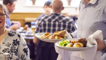 A restaurant setting with diners and waitstaff.