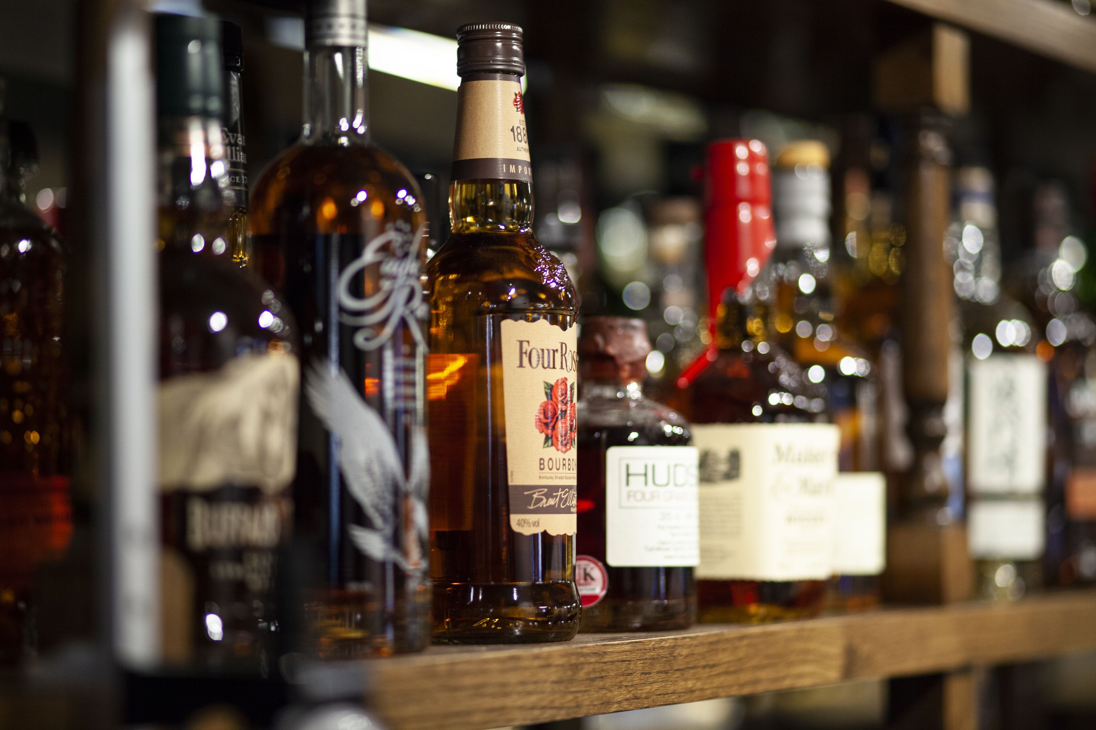 A shelf with various bottles of liquor.