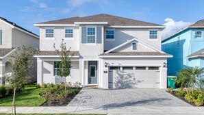 A two-story residential house with a garage, a front lawn, and a driveway.