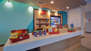 A snack display in a store with various chips and snacks. - avid hotel Detroit Warren by IHG (Warren)