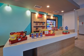 A snack display in a store with various chips and snacks. - avid hotel Detroit Warren by IHG (Warren)
