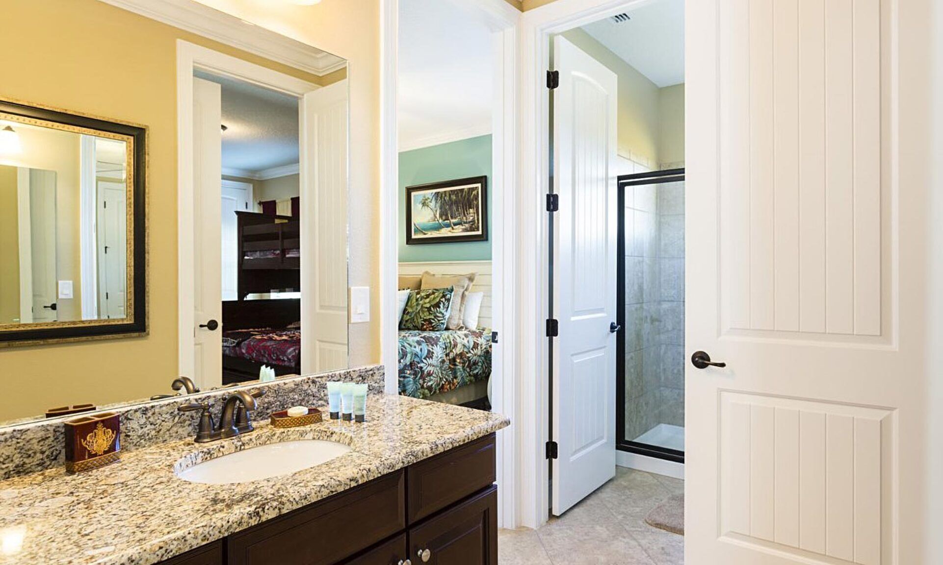 A bathroom with a sink, mirror, and a shower area.