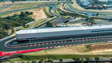 An aerial view of a race track with a large building adjacent to it.