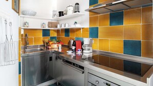 A modern kitchen with stainless steel appliances, a dishwasher, and a coffee maker on the counter. - Villa Le Sirene with Private Jacuzzi, Sea View (Positano)