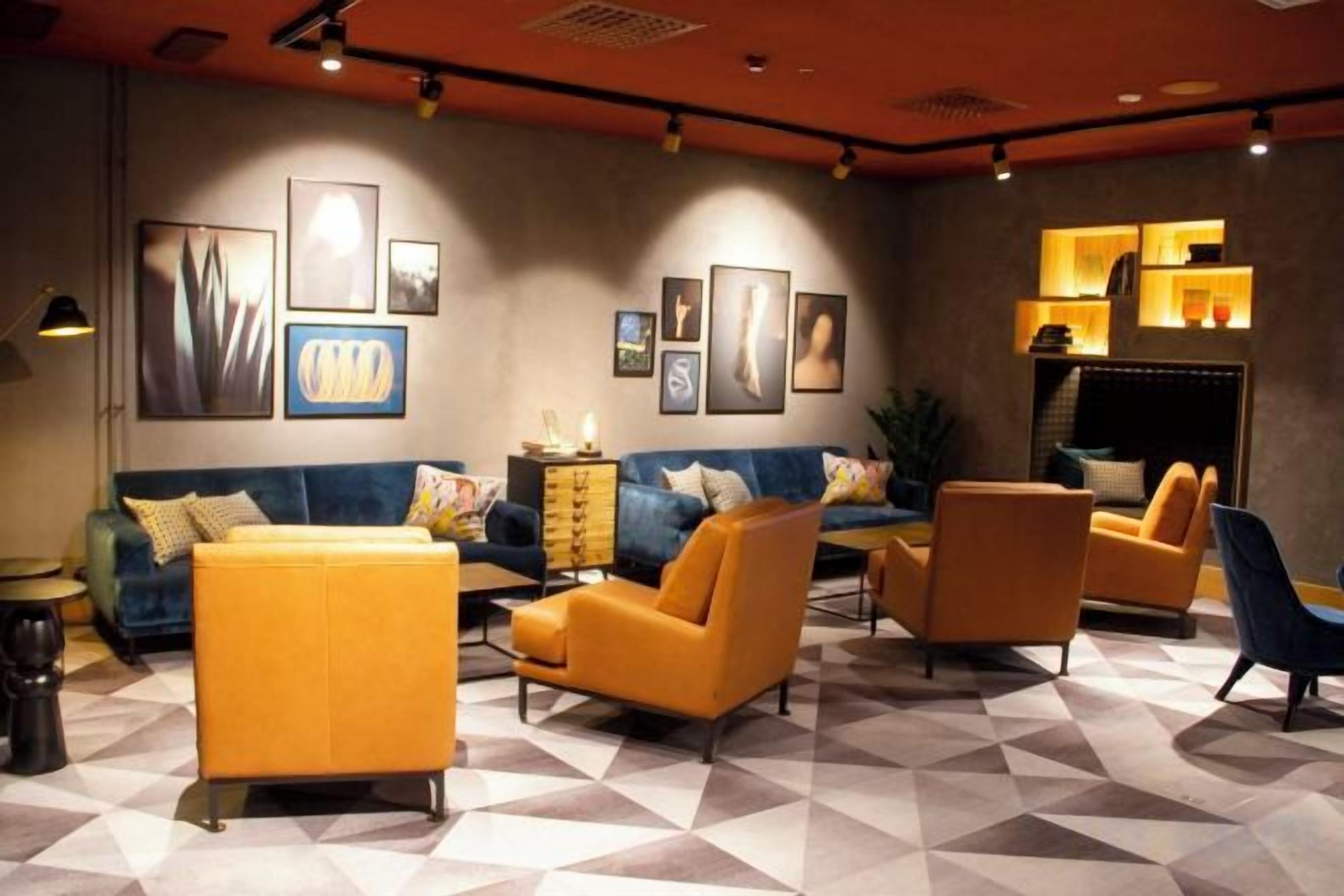 A modern living room with a sofa, armchairs, and a coffee table.