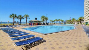A pool area with lounge chairs and a lifeguard station. - Cooks Beach Getaway LLC (Panama City Beach)