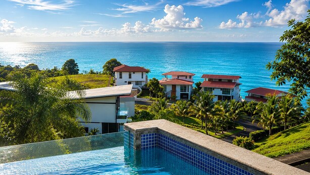 A resort with a pool overlooking the ocean, multiple buildings, and lush greenery. - Family_friendly beach house  (Jama)