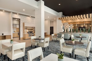 Relax and work in comfort with our central seating area, featuring round tables and comfortable chairs.
