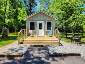 A small cabin with a porch, two chairs, and a mailbox. - Family Get Away Tiny House Cabin with Bunk Room+Pet Friendly! Lake Guntersville (Guntersville)